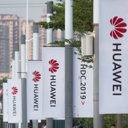 Banners with the Huawei logo are seen outside the venue where the telecoms giant unveiled its new HarmonyOS operating system in Dongguan, China, on August 9, 2019. Photo: AFP