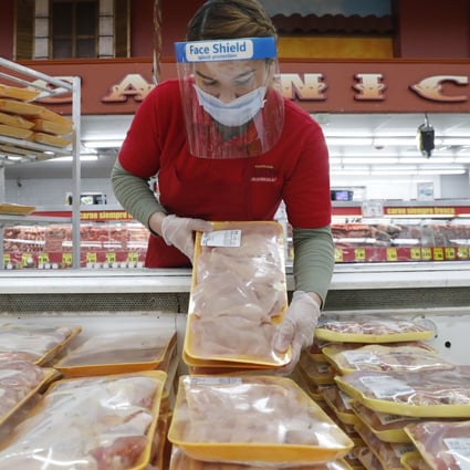 A worker restocks chicken in the meat product section at a grocery store in Dallas, US, on April 29. Rising prices for a variety of commodities are contributing to a jump in prices, with Americans paying more for meat, petrol, items they keep in their homes and even the homes themselves. Photo: AP