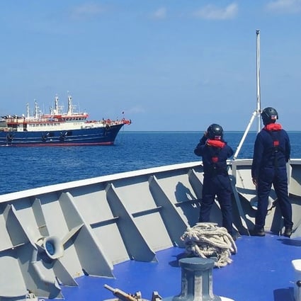 Philippine coastguard personnel monitor Chinese vessels anchored at Sabina Shoal, a South China Sea outcrop claimed by Manila. Photo: Philippine coastguard via AFP