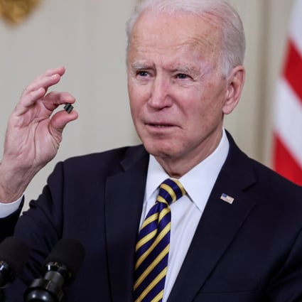 US President Joe Biden holds a chip as he speaks prior to signing an executive order aimed at addressing a global semiconductor shortage, in the State Dining Room at the White House in Washington on February 24. Photo: Reuters