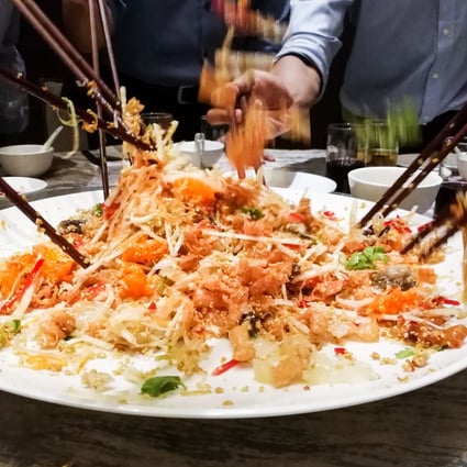 Yee sang salad being tossed during Lunar New Year. Photo: Shutterstock