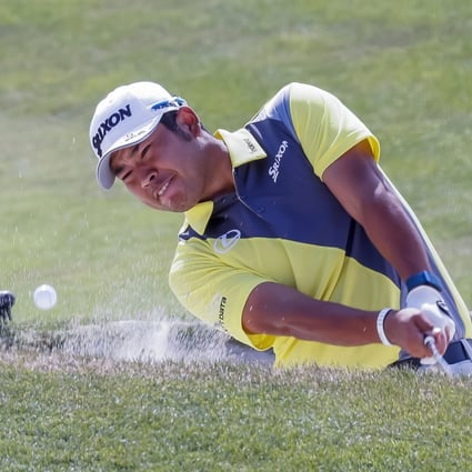 Hideki Matsuyama hits from a bunker at the seventeenth green during a practice round for the 2021 PGA Championship. Photo: Reuters