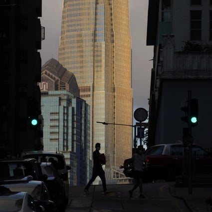 A man walks in front of the IFC tower in Central, Hong Kong, on May 15. Hong Kong is uniquely suited to accommodate the transformation to a new era of finance. Photo: AP
