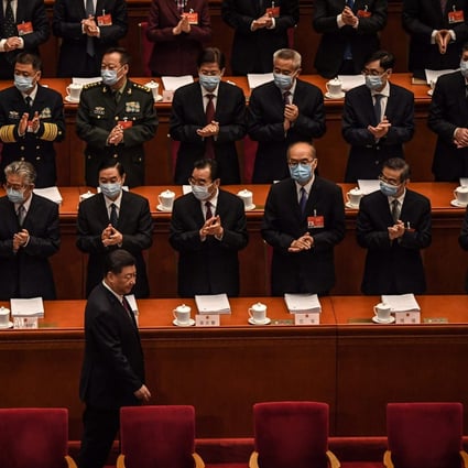 Delegates applaud as China's President Xi Jinping arrives for the opening session of the National People's Congress (NPC) at the Great Hall of the People in Beijing on March 5, 2021. Photo: AFP