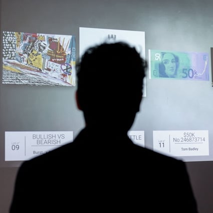 A visitor looks at an NFT digital artwork to be auctioned at the Millon Belgique auction house in Brussels, on May 18. After the sale in March of a collage of 5,000 digital images by the American artist Beeple for US$69 million, the Europeans are getting into the NFT act. Photo: AFP