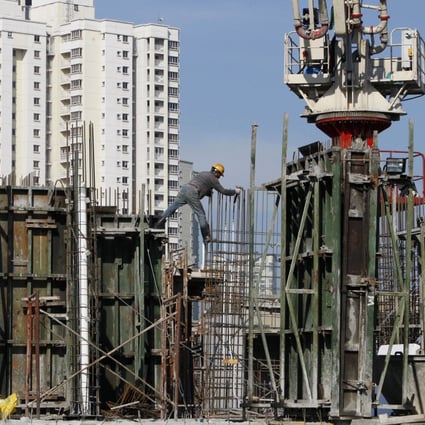 Construction workers build a new condominium tower in a Kuala Lumpur suburb. File photo: AP