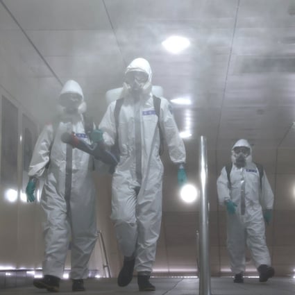 Soldiers in protective suits disinfect a metro station following a surge of Covid-19 infections in Taipei on May 25. After managing the pandemic well, Taiwan has struggled with a rise in cases in the past month. Photo: Reuters