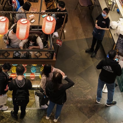 Customers line up to dine at a restaurant in Mong Kok in February, after Hong Kong’s social distancing rules were relaxed to allow four per table and dine-in services until 10pm. Photo: Edmond So