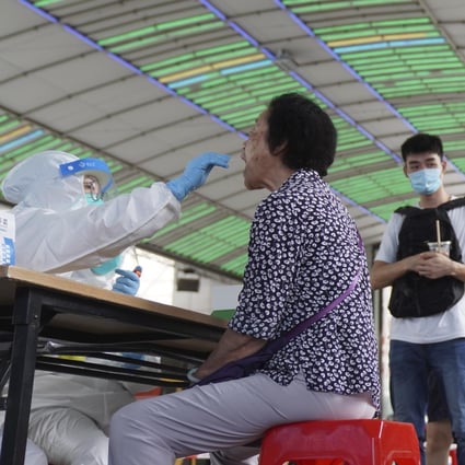Residents get tested for the coronavirus in Guangzhou on Sunday. Photo: AP