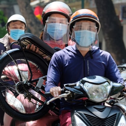 Motorists wear face masks in Hanoi, Vietnam, amid a fresh coronavirus outbreak. Photo: EPA-EFE