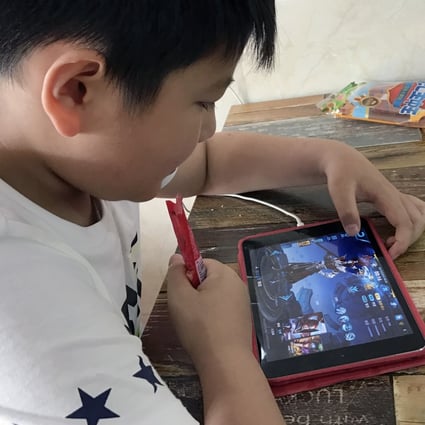 A boy is seen playing Tencent Holdings’ popular fantasy role-playing game Honour of Kings. Photo: SCMP