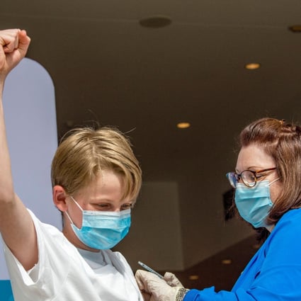 A 13-year-old celebrates being inoculated against Covid-19 at a mass vaccination centre in Hartford, Connecticut, on May 13. The US is allowing children aged 12-15 to receive the Pfizer-BioNTech vaccine. Photo: AFP