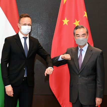 Chinese State Councillor and Foreign Minister Wang Yi greets Hungarian Minister of Foreign Affairs and Trade Peter Szijjarto, in Guiyang, Guizhou province, on Monday. Photo: Xinhua