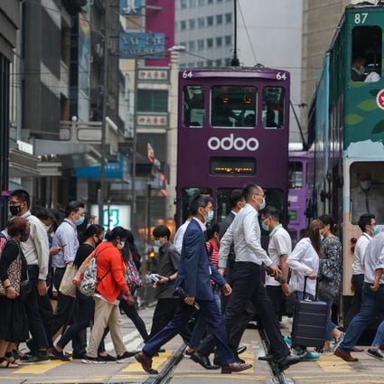 Office workers crossing a busy street in Hong Kong’s financial district in Central. Photo: Felix Wong