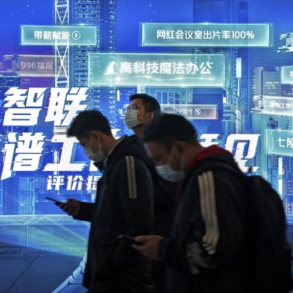 Commuters wearing face masks browse their smartphones as they walk by a mobile phone app advertisement at a subway station in Beijing. Photo: AP