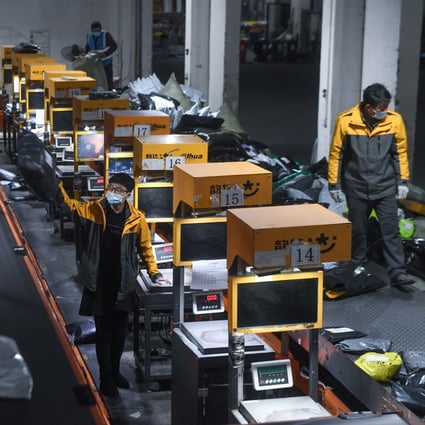 Workers handle packages for delivery at a warehouse in Huzhou, Zhejiang Province, Feb. 8, 2021. The country’s two biggest shopping sprees serve as a barometer of consumer sentiment in the world’s second-largest economy. Photo: Xinhua