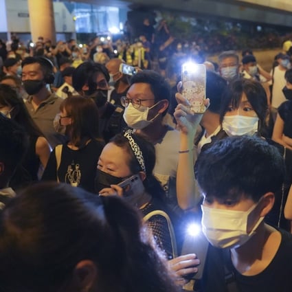 Defiant crowds in Causeway Bay raise their lit mobile phones. Photo: Sam Tsang