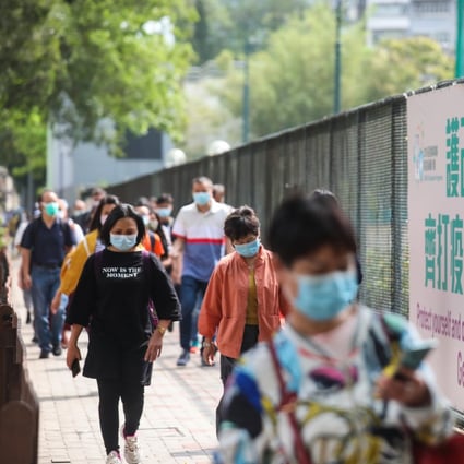 People walk past a banner encouraging Hongkongers to get vaccinated against Covid-19, in Causeway Bay on April 18. Photo: Xiaomei Chen