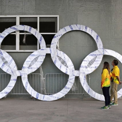 Workers inspect a set of Olympic Rings that are scheduled to be installed inside Olympic Park in Rio de Janeiro, Brazil, in 2016. Photo: AP