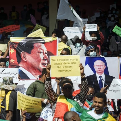 Protesters hold the portraits of Chinese President Xi Jinping and Russian President Vladimir Putin at a rally in Addis Ababa on May 30 against US sanctions over the conflict in Tigray. Photo: AFP