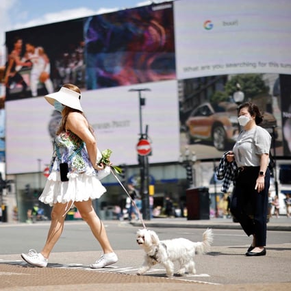People cross the road in Piccadilly Circus, London. Photo: AFP