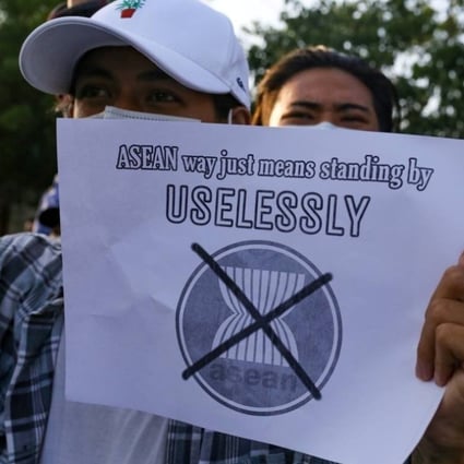 A protester against Myanmar's junta holds a placard criticising the Association of Southeast Asian Nations, during a demonstration in Mandalay on June 5. Photo: Reuters