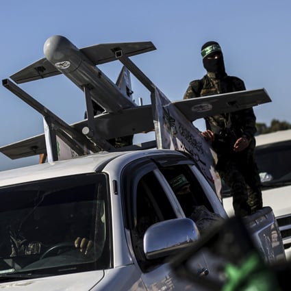 Palestinian Hamas masked gunmen parade with a drone on the back of a truck through the streets of a town in the southern Gaza Strip last month. Photo: AP