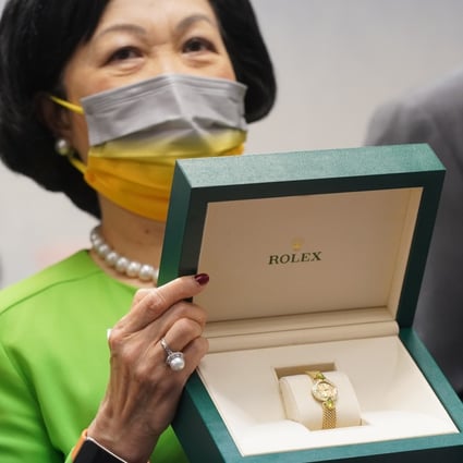 New People's Party chairwoman Regina Ip poses with a Rolex to be offered up in a lottery for vaccinated party allies. Photo: Sam Tsang