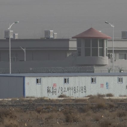 A guard tower and barbed wire fence are seen around a facility in the Xinjiang region, where China is accused of human rights abuses. Photo: AP