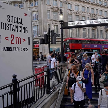 Commuters enter Oxford Circus London Underground station in London. Photo: AFP