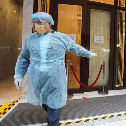 Some workers seen outside a designated quarantine hotel in North Point, Hong Kong, in December 2020. Photo: Felix Wong