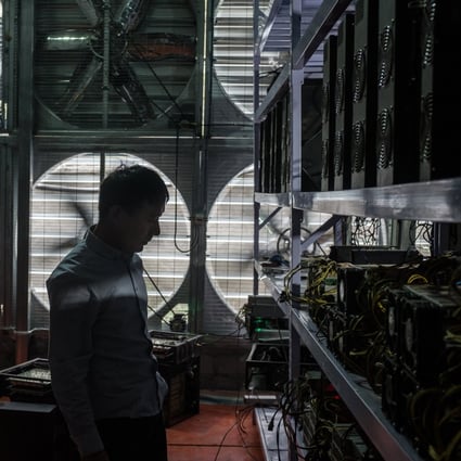 A bitcoin mine owner stands in front of a wall of cooling fans at his mine, where he houses and operates machines for miners who do not want to move to rural Sichuan, in Ngawa Tibetan and Qiang Autonomous Prefecture, on September 27, 2016. Photo: EPA