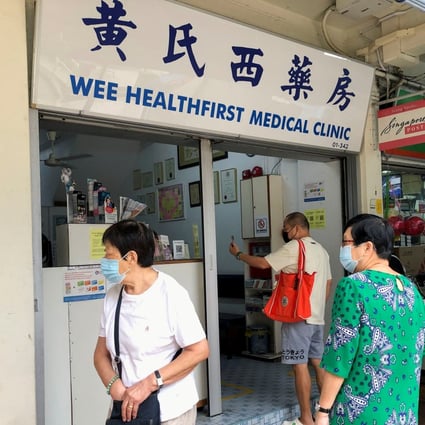 People are seen outside a clinic in Singapore that offers the Chinese-made Sinovac coronavirus jab. Photo: Reuters