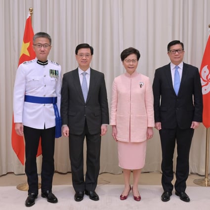 Hong Kong Chief Executive Carrie Lam (second right) with the new Chief Secretary, John Lee (second left), the new Secretary for Security, Tang Ping-keung (right), and the new Commissioner of Police, Siu Chak-yee, on June 24. Photo: Handout