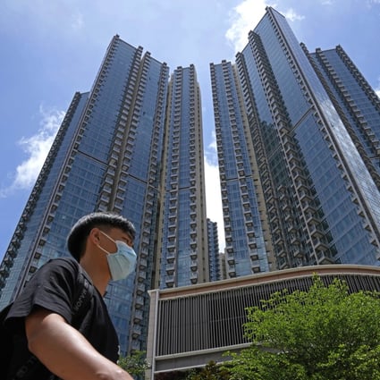 A man walks in front of the Grand Central residential building complex where one of the HK$10.8 million flats will be offered as a prize in a lucky draw for a vaccine incentive. Photo: AP