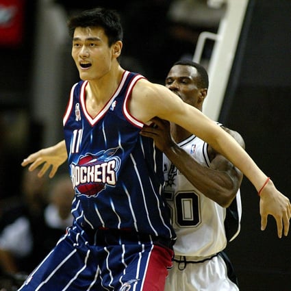 Yao Ming of the Houston Rockets blocks out David Robinson of the San Antonio Spurs in a preseason NBA game on October 23, 2002. Photo: AFP