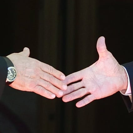 Russian President Vladimir Putin and US President Joe Biden shake hands on June 16. Photo: AP