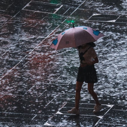 A woman walks through Central after Hong Kong’s first black rainstorm warning of the year was issued at 8.20am on Monday. Photo: Dickson Lee