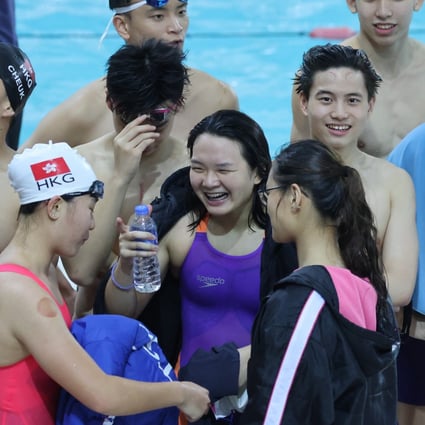 Chloe Cheng (purple swim suit) celebrates with teammates after breaking the Hong Kong record in the women’s 400m individual medley at Victoria Park. Photos: Nora Tam