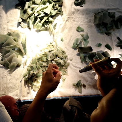 Buyers inspect pieces of jade at a market in Mandalay, Myanmar. Photo: Reuters
