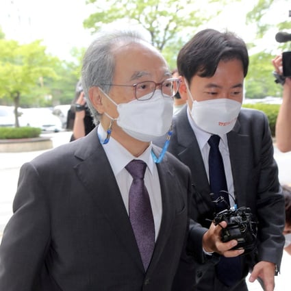 Oh Keo-don, left, arrives at a court to attend his trial on sexual harassment allegations in the southern port Busan on Tuesday. Photo: Yonhap via AFP