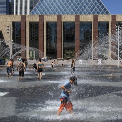 Canadians cool off in the city hall pool as temperatures hit 37 degrees Celsius in Edmonton, Alberta. Photo: The Canadian Press via AP