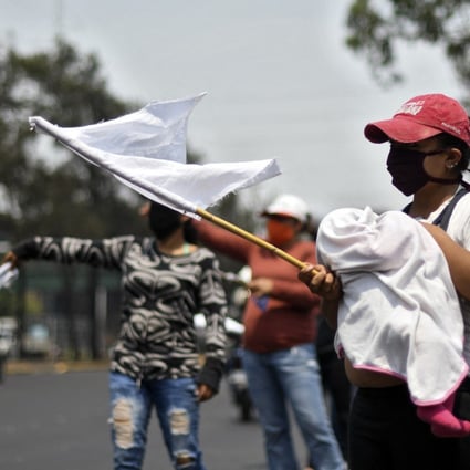 People wave white flags as a signal they need food in Guatemala last year. A similar white flag campaign sprang up in Malaysia over the past week. Photo: AFP