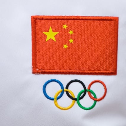 A Chinese flag and Olympic sign are seen on a jacket worn by a Chinese sportsman during a ceremony to launch the flag tour of the Beijing 2022 at Badaling Great Wall in February, 2018. Photo: EPA