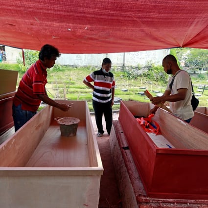 Coffins being prepared for Covid-19 victims at a workshop inside a funeral complex in Jakarta, Indonesia. Photo: Reuters