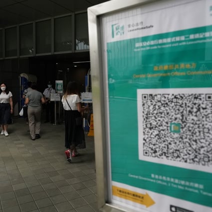 A sign outside government headquarters urges people to use the official Covid-19 risk-exposure app. Photo: Felix Wong
