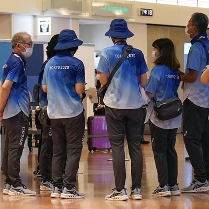 Tokyo 2020 volunteer staff clad in the blue-and-white uniforms. Photo: EPA-EFE