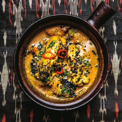 Yellow chicken adobo, a dish from the Philippines, with turmeric and charred coconut. Photo: Conde Nast via Getty Images