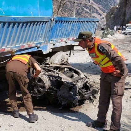 Rescuers inspect the scene of a blast on Wednesday that hit a bus carrying Chinese nationals to the site of Dasu dam in Pakistan. Photo: Rescue 1122 handout via EPA