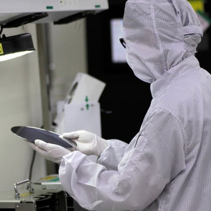 A worker checks a silicon wafer at the Singapore factory of UTAC, which was bought by Wise Road Capital. Photo: Reuters